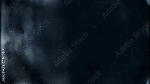 Abstract dark background featuring a midnight emulsion distress texture with subtle film grain and worn vintage photographic chemical effects