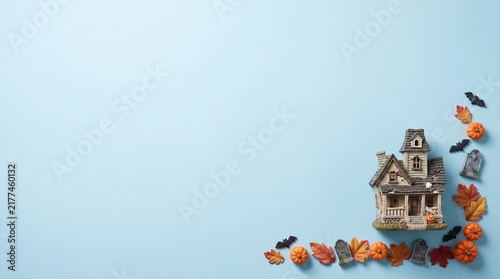 Miniature haunted house with pumpkins and bats, halloween diorama