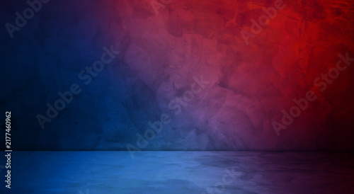 Empty concrete wall and floor dark studio room background with vibrant red and blue neon lighting effect. Abstract textured dark wall product display stand backdrop for product presentation.