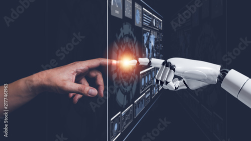Human and robot hands connecting through digital interface, representing artificial intelligence, human AI collaboration, automation, robotics, machine learning, innovation and digital transformation.