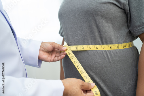 Fotografía Asian woman with fat belly big size overweight and obesity with measure tape