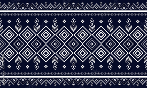 Seamless navy blue and white ethnic geometric pattern with diamond motifs and tribal ornamental borders.