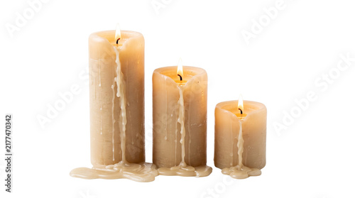 Картината върху платно Three Burning Pillar Candles with Dripping Wax in Descending Heights Isolated on