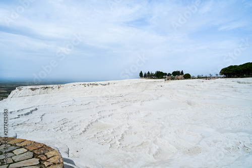 White travertine terraces of Pamukkale overlooking the lake near the town of Pamukkale a world-famous natural wonder and thermal springs Denizli Province, Türkiye 