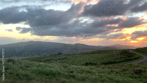 Sunrise over the volcanic crater of Rano Kau on Easter Island, Chile. The rising sun illuminates the vast crater and Pacific Ocean, volcanic landscape