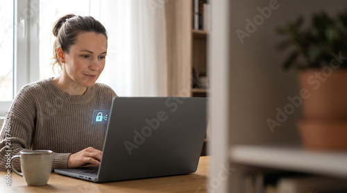 Remote worker using laptop with digital security padlock icon for data protection in home office