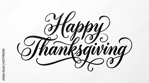 Happy Thanksgiving elegant calligraphy text with swirls on white background