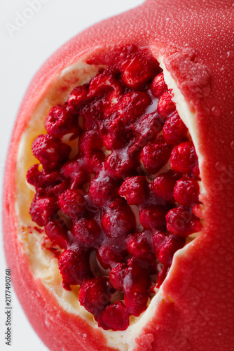 Принти на полотні Macro close up of red berry filling inside pomegranate shaped mousse dessert, de
