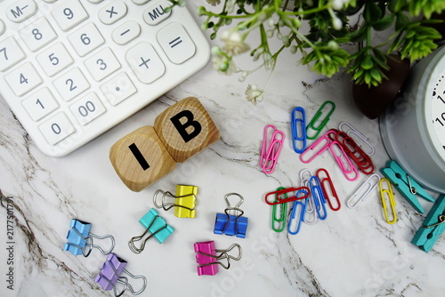 Bild auf Leinwand IC (Information Coefficient) alphabet letters with calculator and alarm clock on