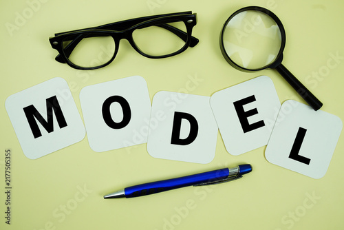 Foto MODEL alphabet letters with magnifying glass, eye glasses and pen on yellow back