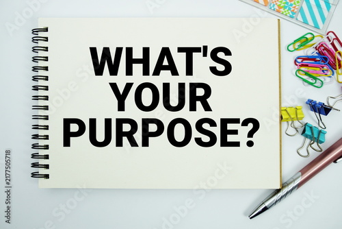 What's Your Purpose? text message written on notepad with stationery flat lay on white background