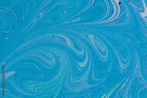 Full frame abstract blue and turquoise fluid paint texture. Marbling background with fine swirls.