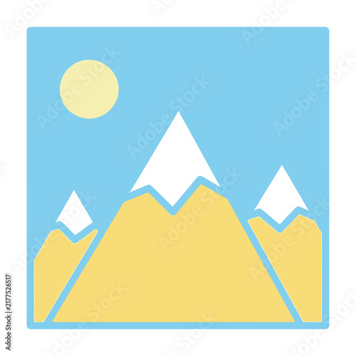 Mountain landscape with snow capped peaks under sunny blue sky