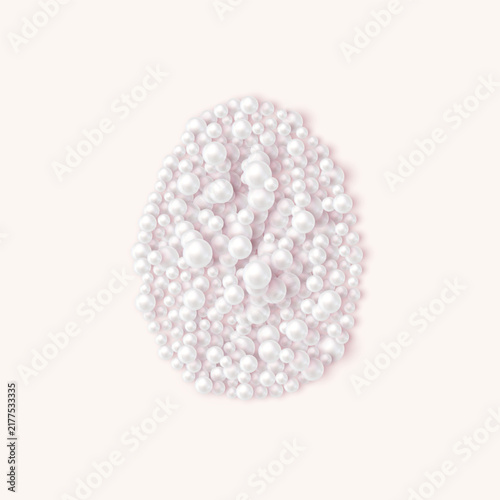 Pearl Easter egg made of white pearls on soft pink background
