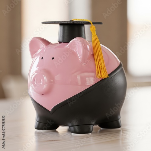 A pink ceramic piggy bank wearing a black graduation gown and cap with a yellow tassel sits on a wood surface against a blurred background, finance, planning, conceptual