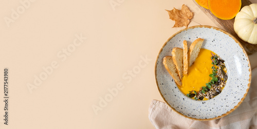 Pumpkin puree soup with croutons. Autumn menu top view, flat lay with copy space