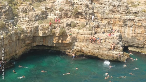 High Angle View of People Cliff Jumping in Slow Motion at Lama Monachile, Polignano a Mare