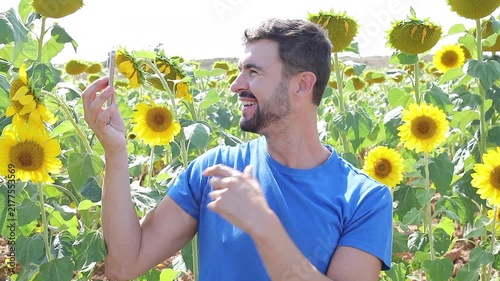 Influencer filming videos from a sunflowers field during the summer time 