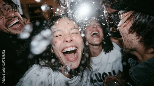 Joyful Young Friends Laughing and Getting Splashed at Party