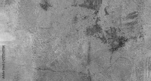 Full frame monochrome grey cement wall texture featuring a rough, uneven surface with subtle scratches and mottled grey tones, ideal for raw industrial architectural backgrounds.