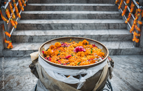 Bright marigold flowers float in a bowl, a in Kathmandu, Nepal