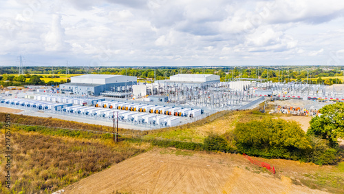Battery energy storage facility progressing towards completion with newly installed battery units, inverters and high voltage substation equipment in Norwich, Norfolk, UK storing power from wind farms