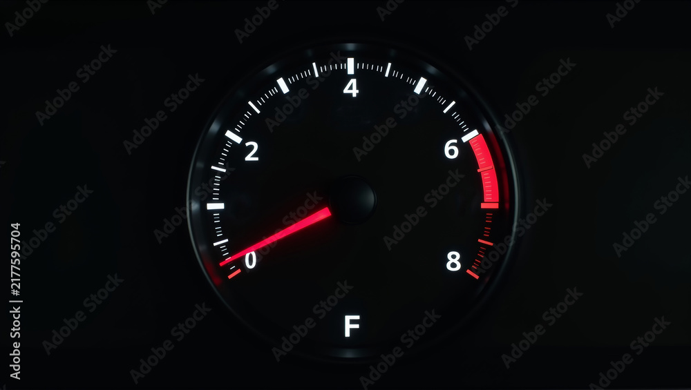Fototapeta premium Car tachometer with red needle indicating engine revolutions per minute, showing the redline limit for optimal performance
