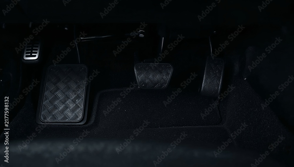 Fototapeta premium Car pedals in a vehicle cabin, accelerating, braking, and clutching while driving, manual transmission concept