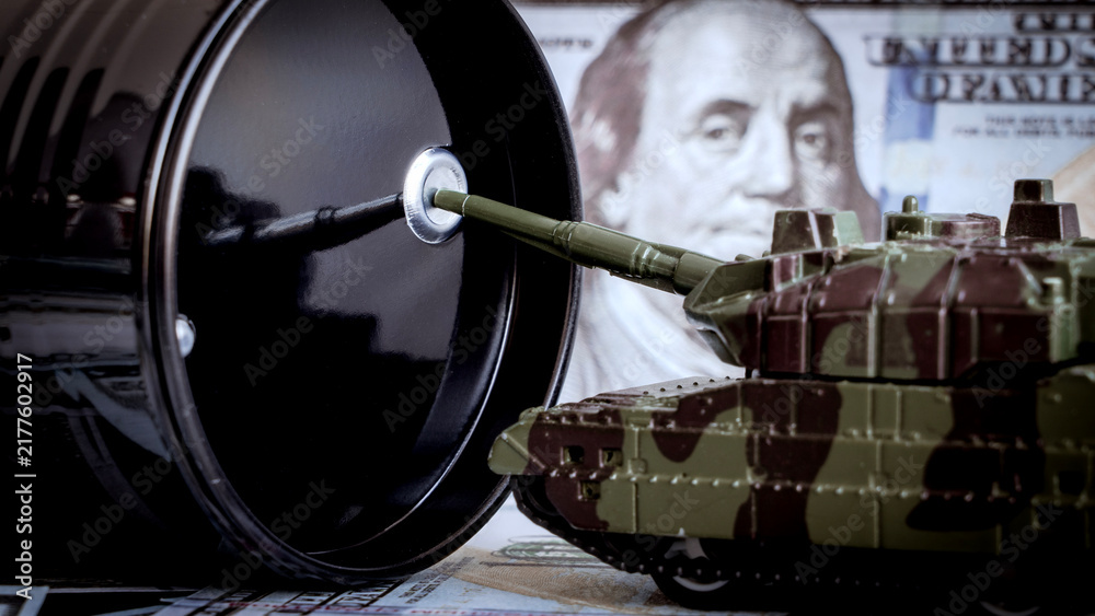 Obraz premium Black barrel looms large beside a toy tank