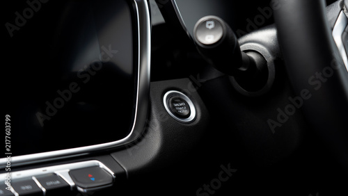 Dark interior highlights start button and gear lever