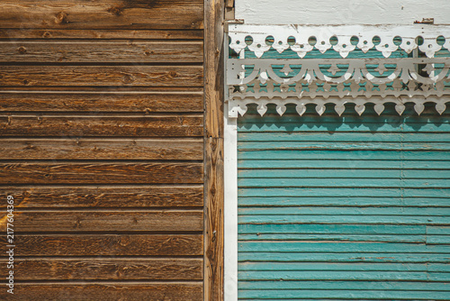 Side by side weathered, unpainted wood next to painted, ornate, cute building facade in Ouray, Colorado