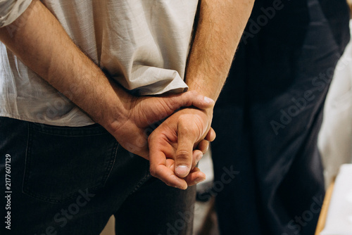 Obraz na płótnie Person standing with hands clasped behind back