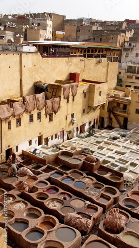 Bild auf Leinwand Vats of chemicals and dyes, with hides hanging above to dry, in the courtyard of