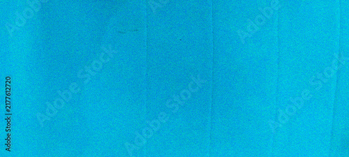Vibrant turquoise fabric texture, bright cyan textile background, close-up of soft blue cloth material for fashion design