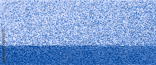 Blue grainy texture background, minimalist two-tone noise pattern, abstract stippled paper effect, artistic gradient surface for graphic design