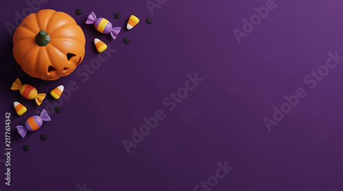 Orange pumpkin jack o lantern with sweet candy on a dark purple background for halloween celebration