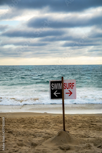 Картината върху платно Beach signpost indicating separate directions for swimming and surfing areas