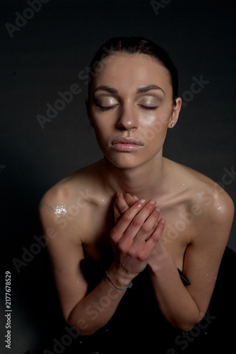 Cuadro en lienzo A portrait of a nude young woman with white artistic makeup on her face and neck