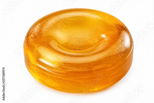Hard glossy translucent candy resting on white studio surface
