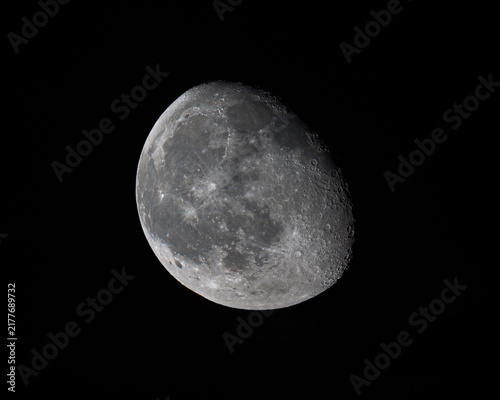 Fotografie A detailed view of the waxing gibbous Moon against the dark night sky, revealing