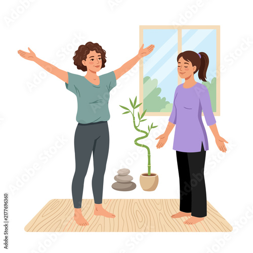 Two women practicing yoga and meditation in a bright, minimalist room with a window overlooking greenery.