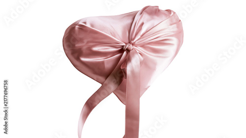 Obraz na plátně Isolated soft shimmering pink textile artfully folded and tied with a graceful bow