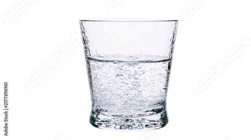 Konstfotografi Isolated transparent glass of refreshing sparkling water with numerous bubbles,