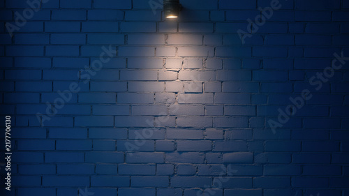 Dark blue brick wall background with spotlight, moody textured brickwork surface, illuminated navy masonry backdrop for product display