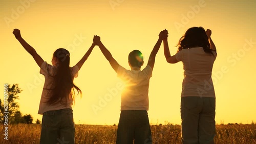 Boy girl raise their arms sky jump. Group children playing in park, children teamwork. Kids active games, concept success victory. Team winning children. Family teamwork. Friends together outdoors