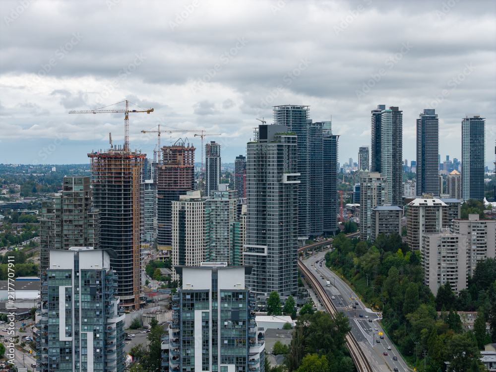 Obraz premium Burnaby Skyline With High-Rise Condos and Construction Cranes Overlooking Greater Vancouver, British Columbia