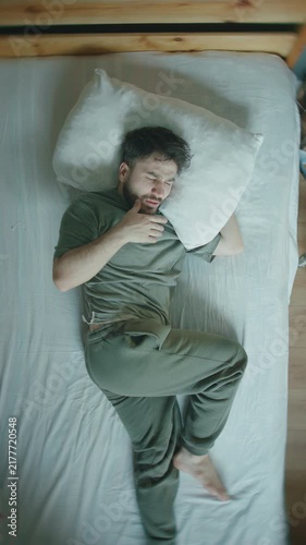 Man Waking Up in Panic Heart Palpitations Anxiety Attack Overhead Bed Sleep ,vertical video