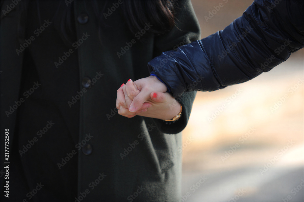 Fototapeta premium A man and a woman holding hands affectionately