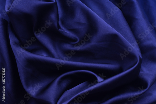 Foto Dark blue elegant, soft, silk fabric with folds and twist creating flow and move