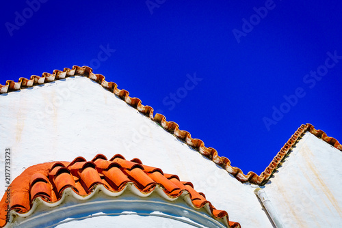 Greek church roof tiles against blue sky Crete Greece
